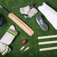 Cricket equipment on the grass from above